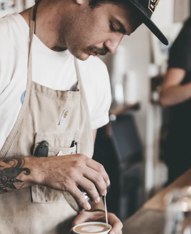 barista pouring coffee